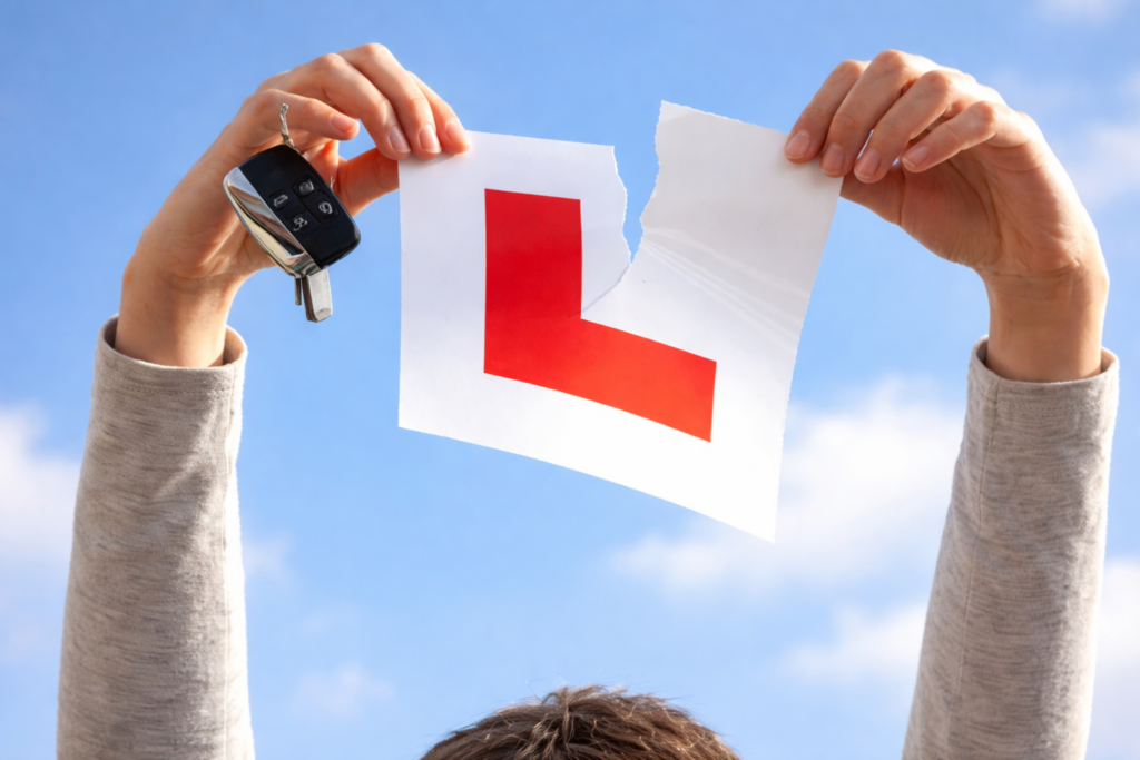 Learner driver tearing L plate while holding car keys